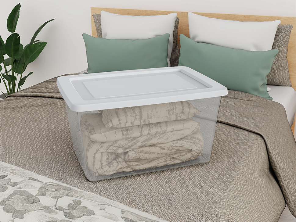 Clear storage bin on bed with blanket inside